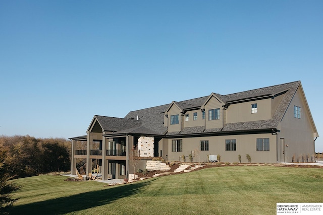 back of house with central AC and a lawn