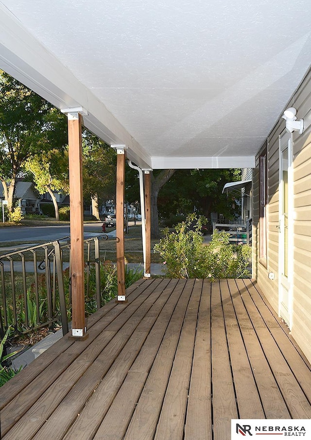 wooden terrace featuring covered porch