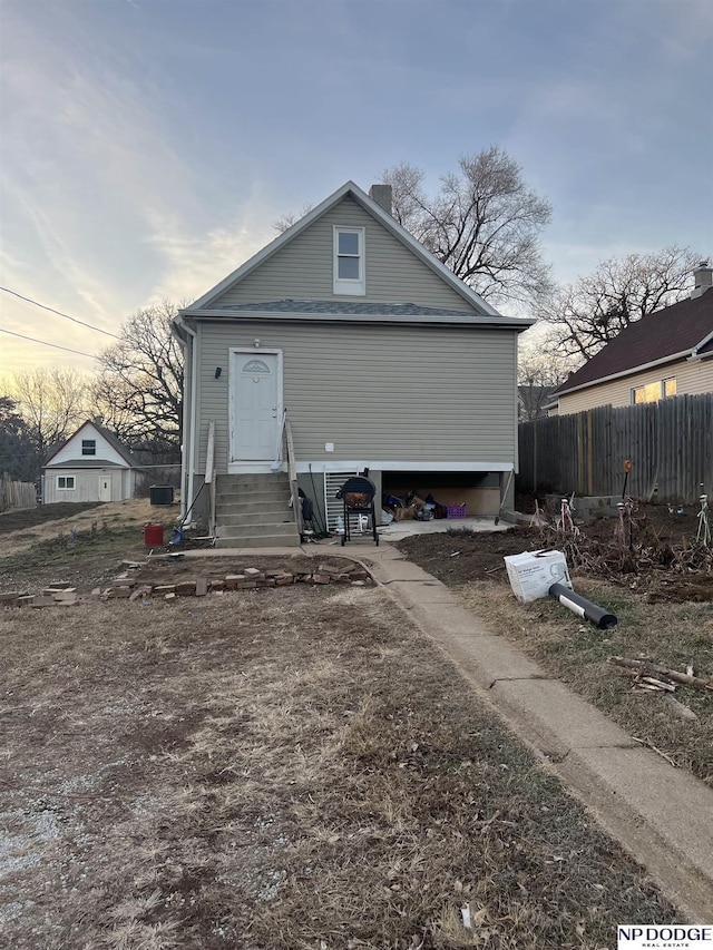 view of back house at dusk