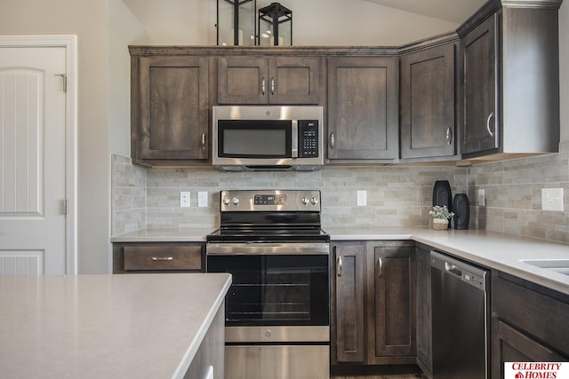 kitchen featuring stainless steel appliances, backsplash, and dark brown cabinets