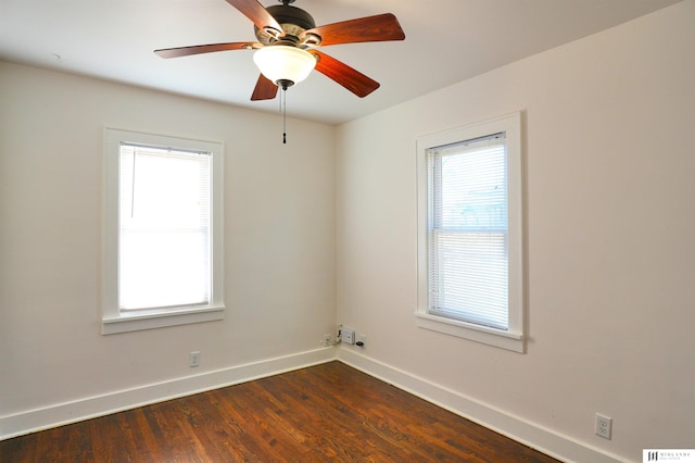 empty room featuring ceiling fan and dark hardwood / wood-style flooring