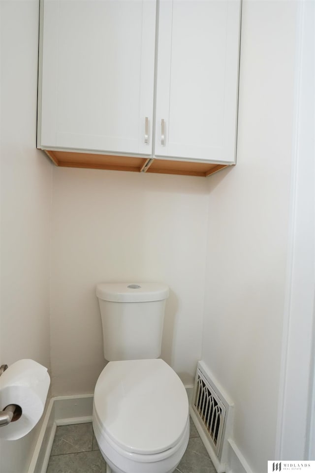 bathroom with tile patterned flooring and toilet