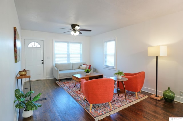 living room featuring ceiling fan and dark hardwood / wood-style floors