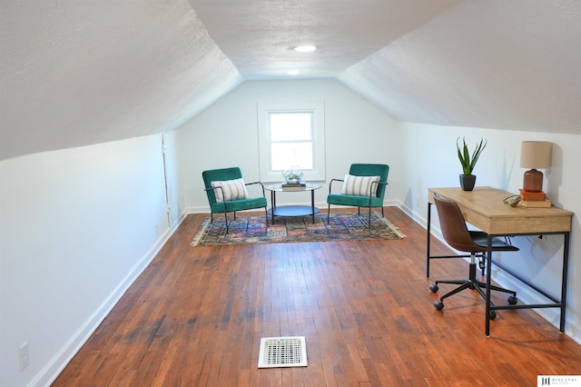 office featuring lofted ceiling, dark hardwood / wood-style flooring, and a textured ceiling