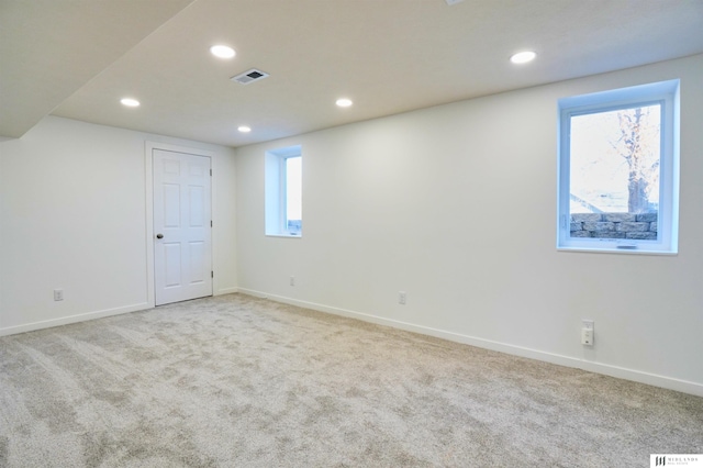 interior space with a healthy amount of sunlight and light carpet