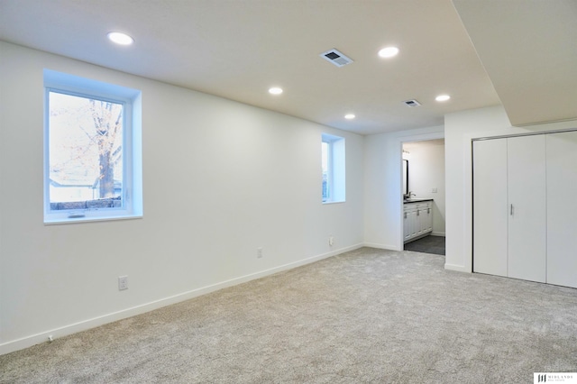 basement featuring light colored carpet