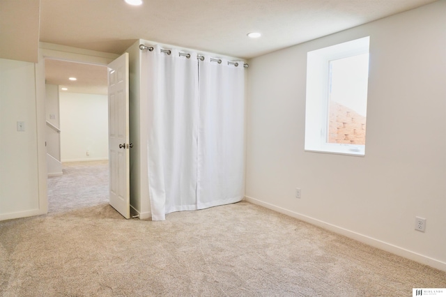 empty room with light colored carpet