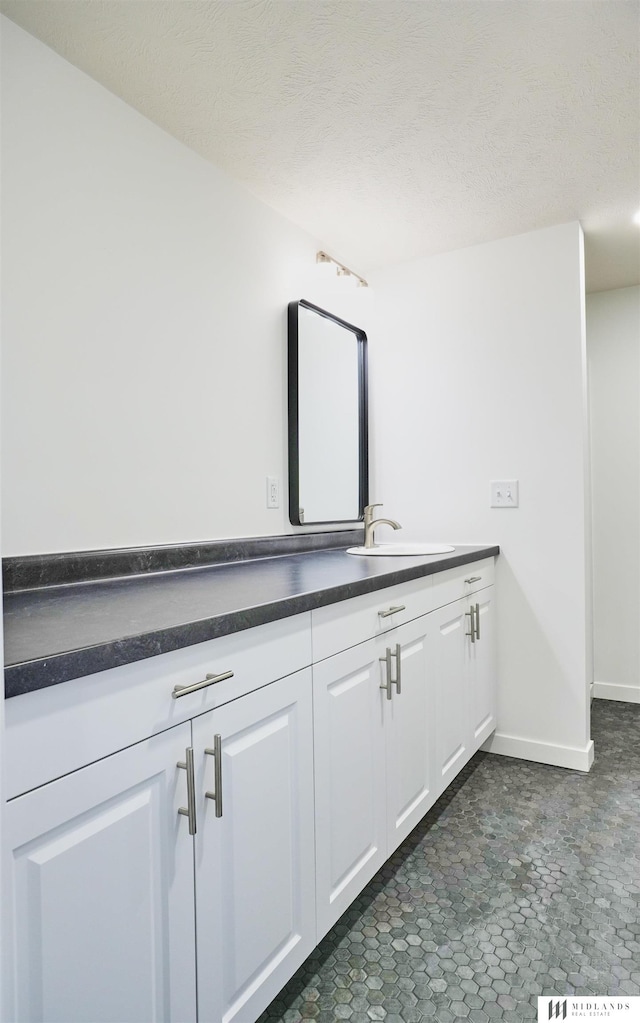 bathroom featuring vanity and a textured ceiling