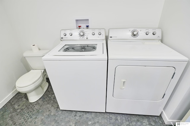 clothes washing area with tile patterned flooring and washing machine and clothes dryer