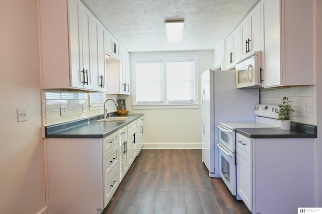 kitchen featuring sink, white appliances, backsplash, and white cabinets