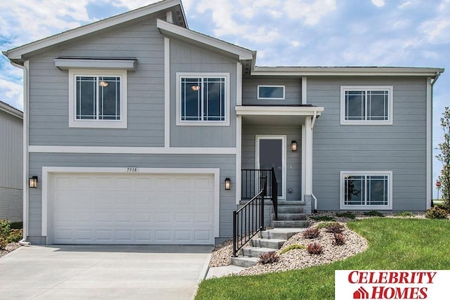 bi-level home with a garage and a front lawn