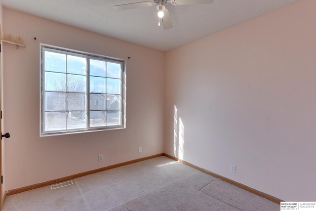 unfurnished room with ceiling fan and light colored carpet