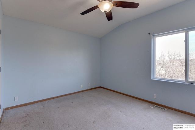 carpeted empty room with vaulted ceiling and ceiling fan