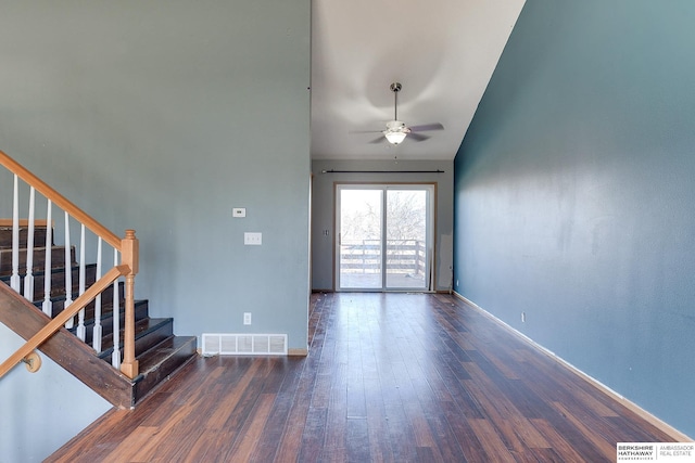 empty room featuring ceiling fan, lofted ceiling, and dark hardwood / wood-style floors