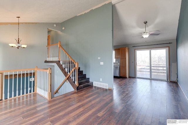 unfurnished living room featuring dark wood-type flooring, lofted ceiling, and ceiling fan with notable chandelier