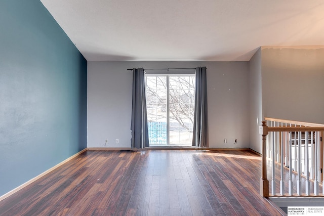 spare room featuring dark wood-type flooring