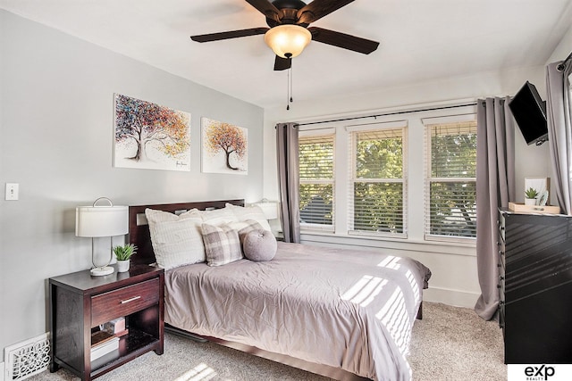 bedroom featuring light carpet and ceiling fan