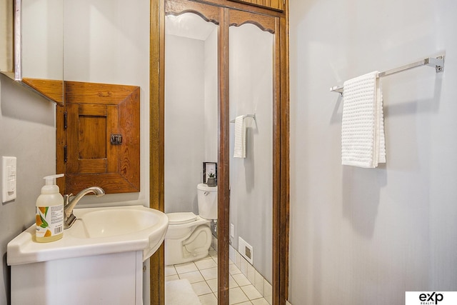 bathroom with tile patterned floors, vanity, and toilet