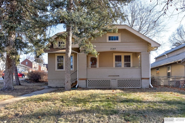 bungalow-style home with a porch and a front yard