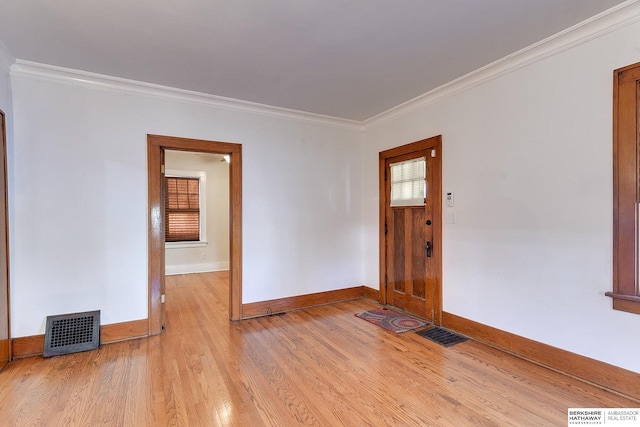 interior space with ornamental molding and light hardwood / wood-style flooring