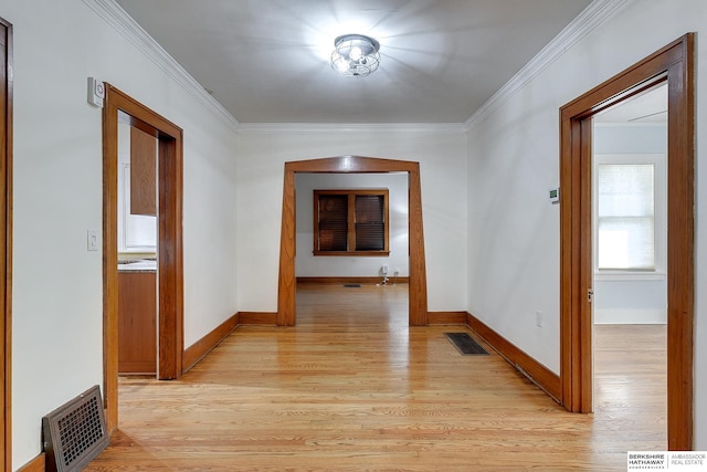 hall featuring light wood-type flooring and ornamental molding