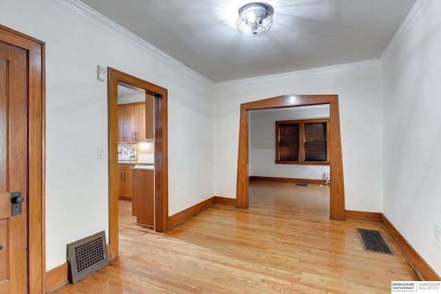 hallway featuring light hardwood / wood-style flooring and crown molding