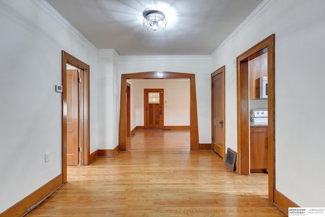 corridor featuring crown molding and light hardwood / wood-style flooring