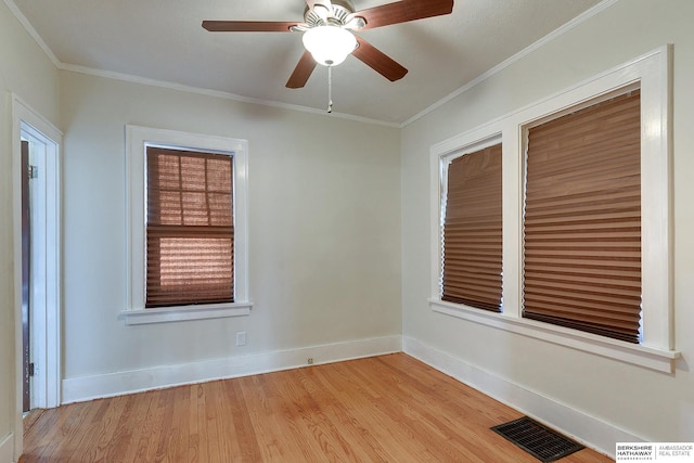 empty room with ceiling fan, ornamental molding, and light hardwood / wood-style flooring