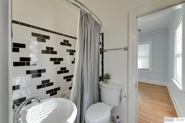 bathroom featuring sink, hardwood / wood-style floors, a shower with curtain, toilet, and crown molding