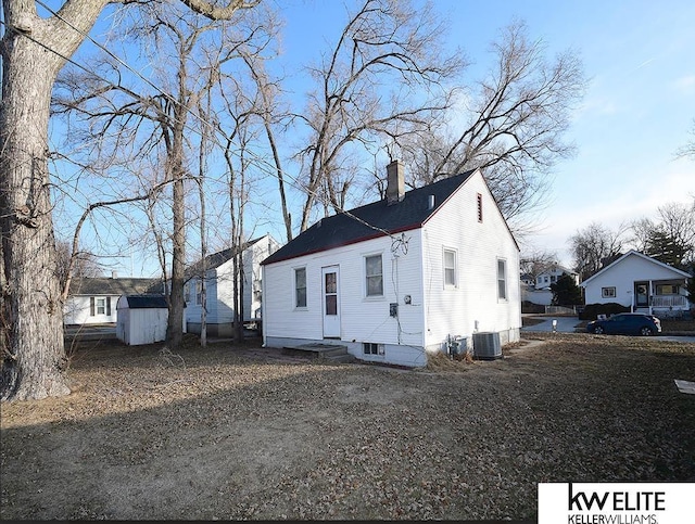 exterior space with central air condition unit and a storage shed