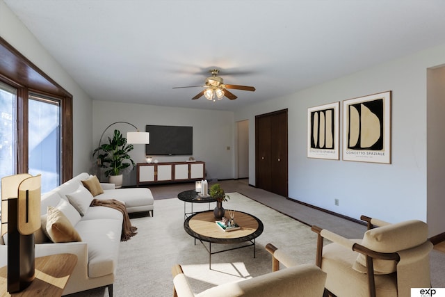 carpeted living room featuring ceiling fan