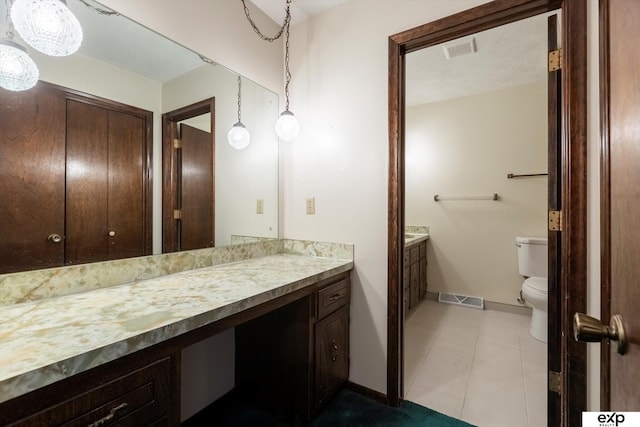 bathroom with toilet and vanity