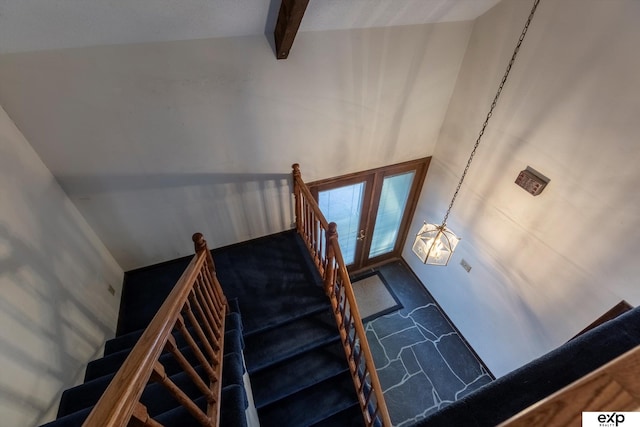 staircase with high vaulted ceiling, french doors, beamed ceiling, and an inviting chandelier