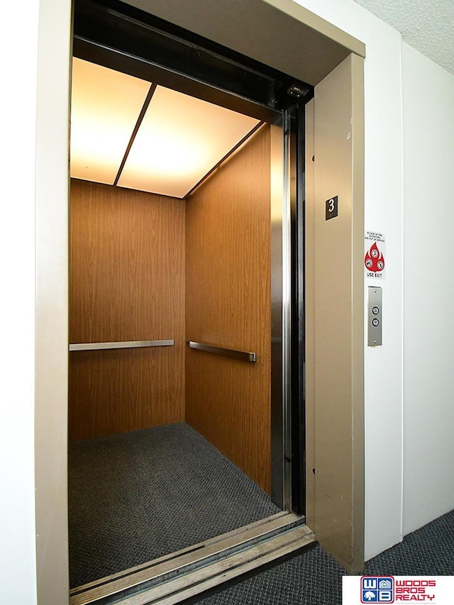 interior details featuring elevator and wooden walls