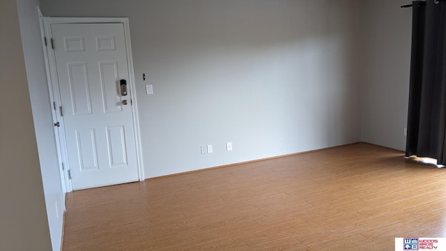 unfurnished room featuring light wood-type flooring