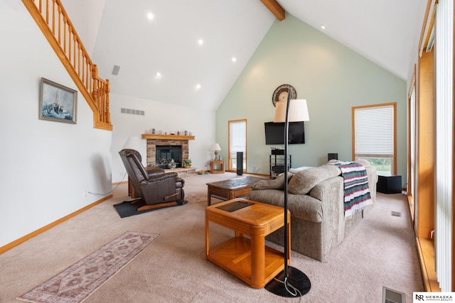 living room featuring a fireplace, beamed ceiling, light colored carpet, and high vaulted ceiling