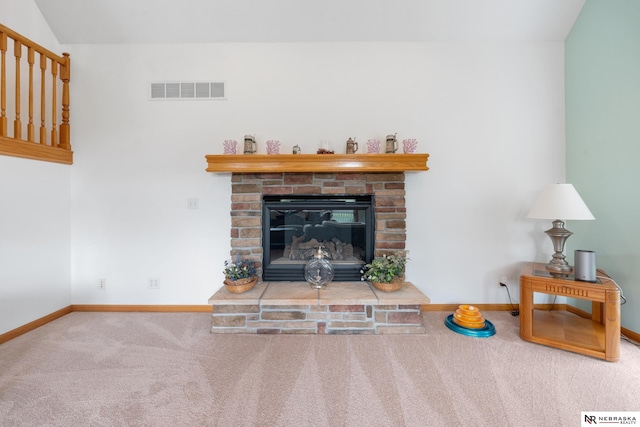 living room with carpet and a fireplace