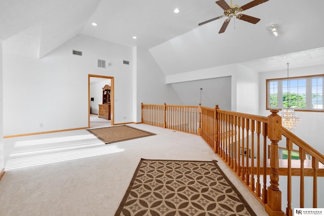 additional living space featuring light carpet, vaulted ceiling, and ceiling fan with notable chandelier