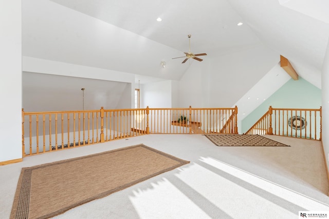 additional living space with ceiling fan, carpet flooring, and lofted ceiling with beams