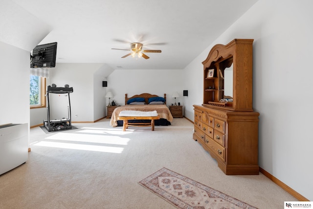 carpeted bedroom with ceiling fan and vaulted ceiling