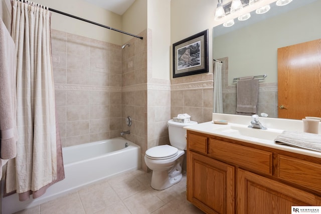 full bathroom with toilet, tile patterned flooring, tile walls, shower / bath combination with curtain, and vanity