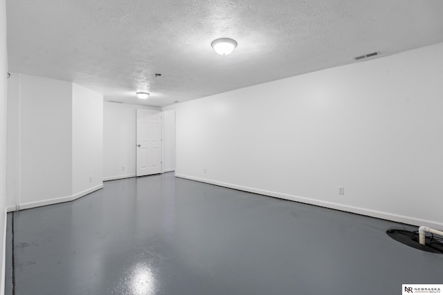 basement featuring a textured ceiling