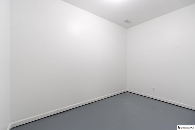 spare room with concrete floors