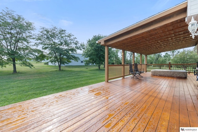 wooden terrace featuring a lawn