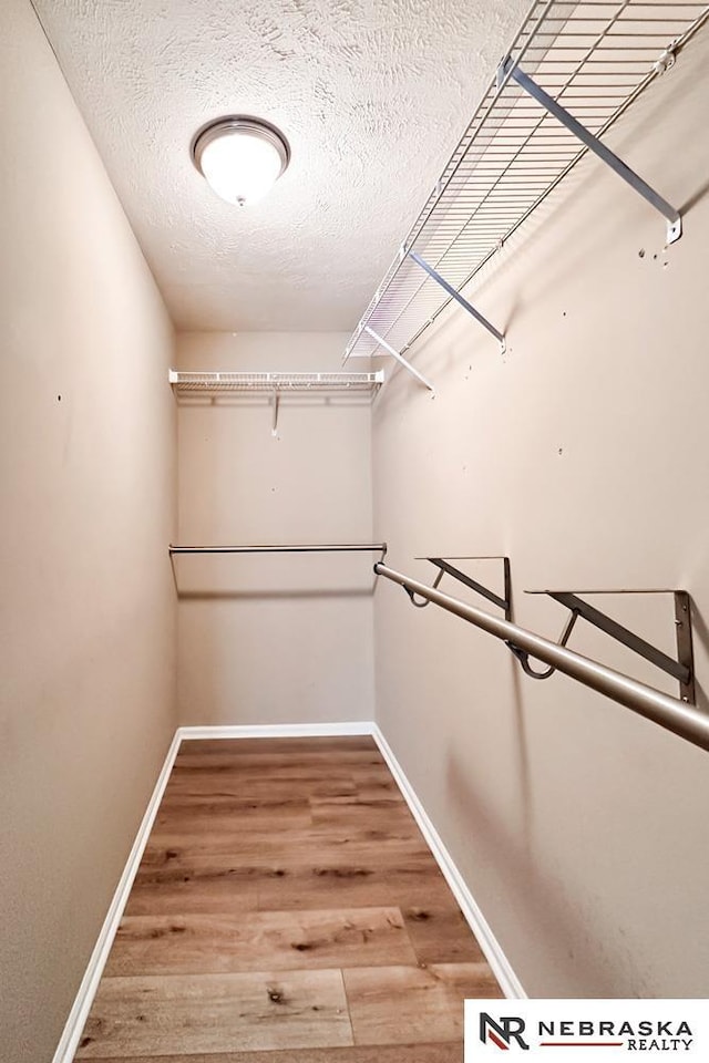 walk in closet featuring hardwood / wood-style floors