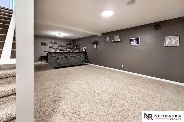 interior space featuring indoor bar, beamed ceiling, and carpet flooring