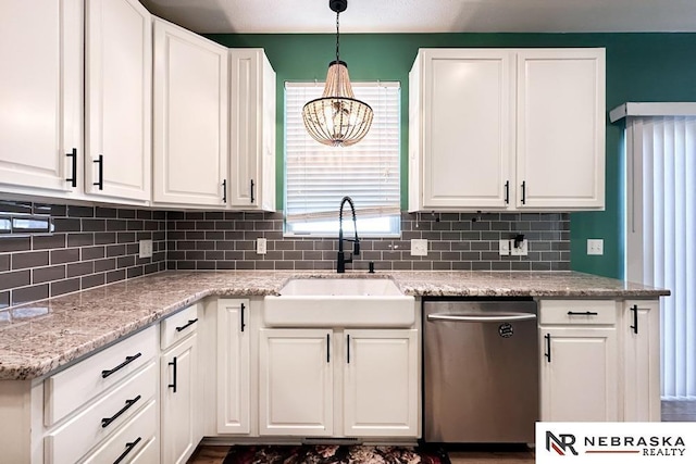 kitchen featuring dishwasher, pendant lighting, sink, light stone countertops, and white cabinets