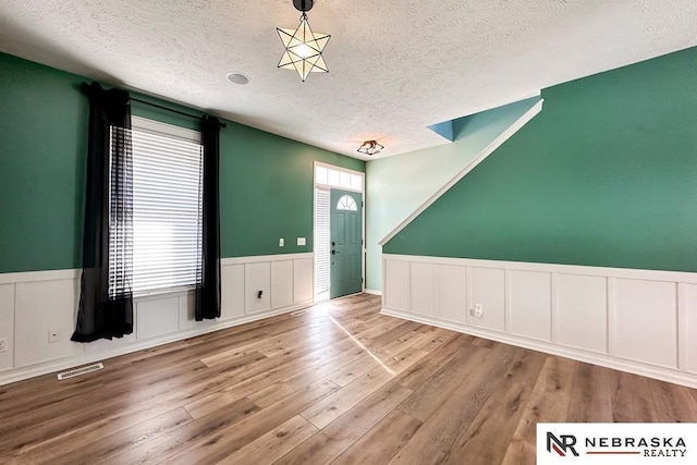 foyer with a textured ceiling and wood-type flooring