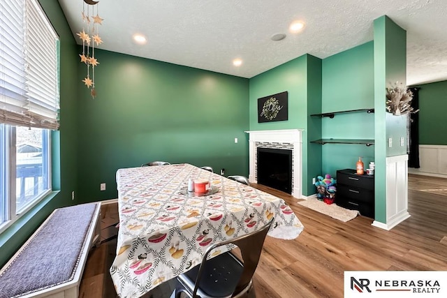 bedroom with hardwood / wood-style floors and a textured ceiling