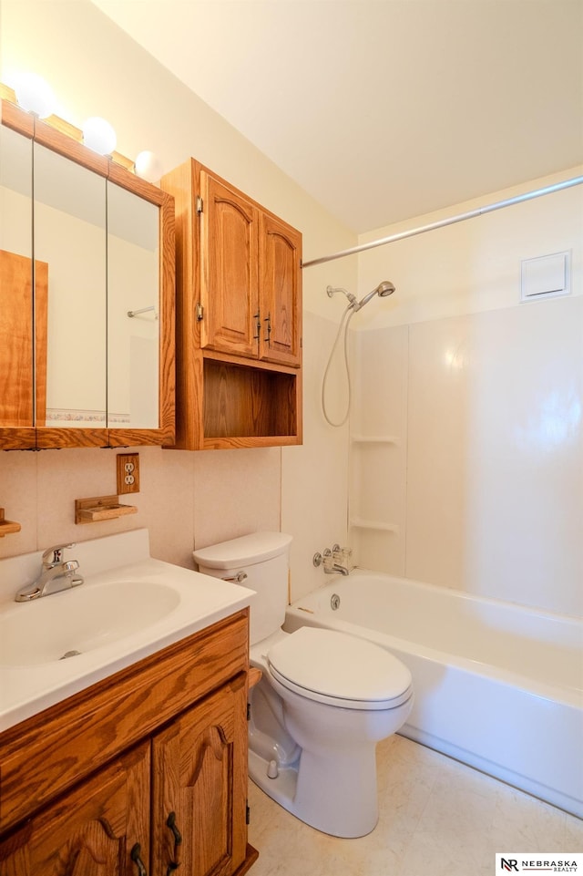 bathroom featuring toilet, tub / shower combination, and vanity